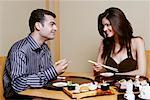 Close-up of a young couple eating Japanese food