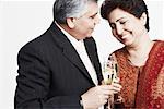 Close-up of a mature couple toasting with champagne flutes