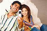 High angle view of a young couple taking a photograph of themselves