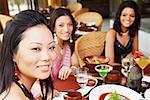 Three young women dining in a restaurant