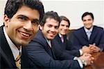 Portrait of four businessmen sitting in a conference room