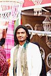 Portrait of a young man standing in a market