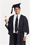 Portrait of a male graduate holding a diploma