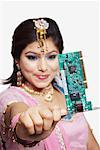 Close-up of a young woman holding a circuit board