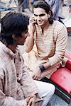 High angle view of two young men sitting in a rickshaw