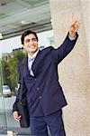 Businessman carrying a bag and waving