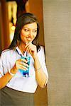 Close-up of a young woman holding a glass of cocktail