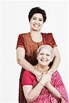 Portrait of a mature woman and her daughter smiling