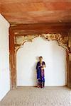 Portrait of a young woman standing in a prayer position, Agra Fort, Agra, Uttar Pradesh, India