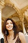 Close-up of a young woman looking sideways and smiling, Agra Fort, Agra, Uttar Pradesh, India
