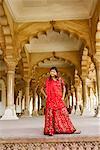 Low angle view of a young woman standing looking away, Agra Fort, Agra, Uttar Pradesh, India