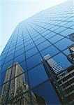 United States, New York, building reflected in skyscraper's facade, low angle view