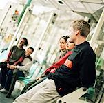 Young people sitting in bus station