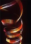 Spiraling light effect, reds and yellows.