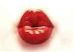 Woman's mouth with red lipstick purckering, blurred, close-up