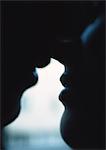 Couple kissing, silhouette, close-up