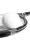 Tennis racket and ball, blurred, close-up, b&w.