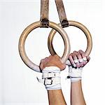 Gymnast's hands holding rings, side view, close-up