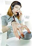 Woman with headset holding futuristic device
