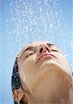 Woman under shower, close up