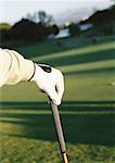 Hand on golf club, close-up