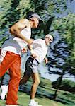 Two mature joggers in park, low angle view