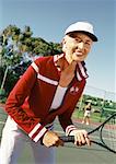 Mature woman holding tennis raquette, portrait