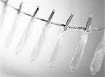 Condoms hanging on washing line, close-up