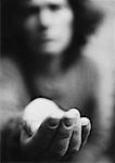 Woman holding hand out, blurred, b&w