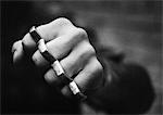 Hand with brass knuckles, close-up, b&w