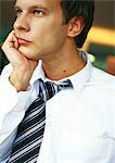 Businessman with hand under chin, portrait