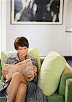 Businesswoman sitting reading newspaper
