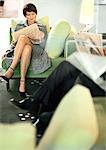 Businesspeople sitting reading newspaper