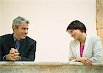 Businessman and woman talking and smiling