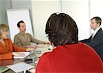 Group of business people sitting at table having a meeting.