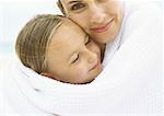 Mother and daughter wrapped in towel, portrait