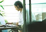 Man using laptop on terrace