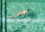 Woman swimming in pool, full length
