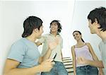 Four young friends meeting in stairway