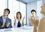 Business team clapping in meeting