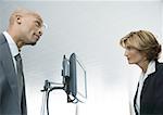 Businessman and female airline attendant staring at each other