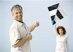 Mature couple flying kite on beach