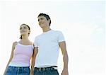 Young couple walking outdoors, front view