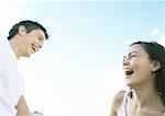 Young couple outdoors, laughing