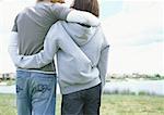 Young couple walking outdoors, rear view