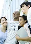 Group of college students standing close together, smiling