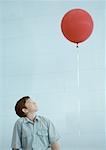 Boy looking up at balloon
