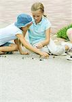 Suburban Kinder spielen Murmeln auf asphalt