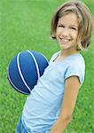 Girl holding basketball, portrait