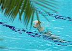 Woman lifting head out of water in pool